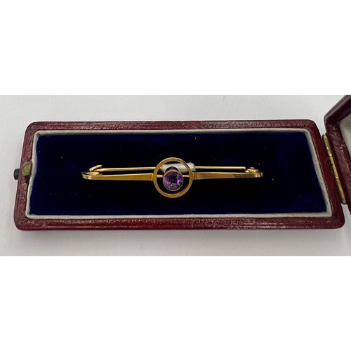 84 - An 9 carat gold Art Deco target brooch set with a circular amethyst in a red leather silk lined pres... 