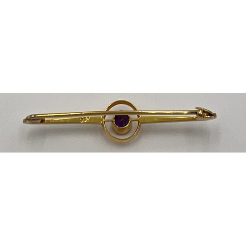 84 - An 9 carat gold Art Deco target brooch set with a circular amethyst in a red leather silk lined pres... 