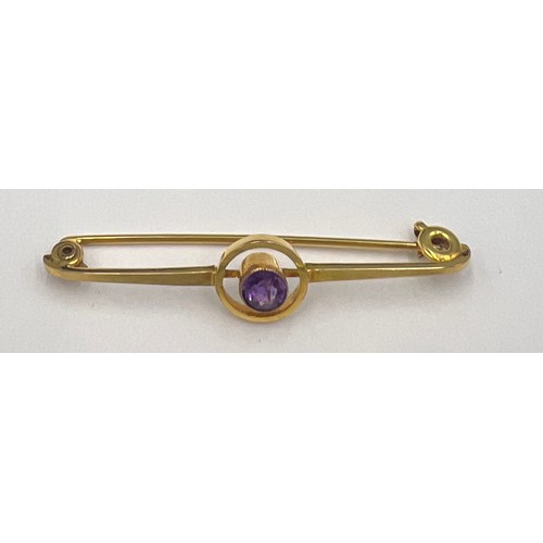 84 - An 9 carat gold Art Deco target brooch set with a circular amethyst in a red leather silk lined pres... 