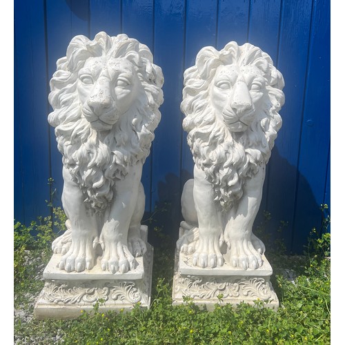 97 - A pair of decorative lions. Base measures 32cm w x 36cm. Height of lions 80cm.