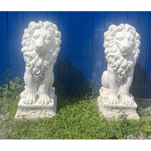 97 - A pair of decorative lions. Base measures 32cm w x 36cm. Height of lions 80cm.