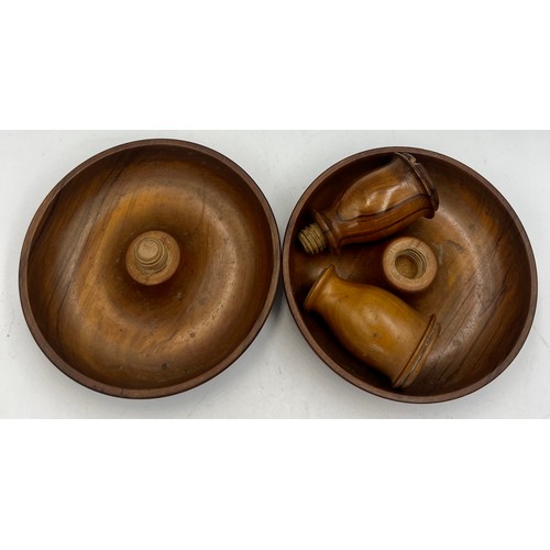 144 - A pair of 19thC walnut treen ‘Brighton Bun’ travelling portable dwarf candlesticks. 10.5cm diameter.