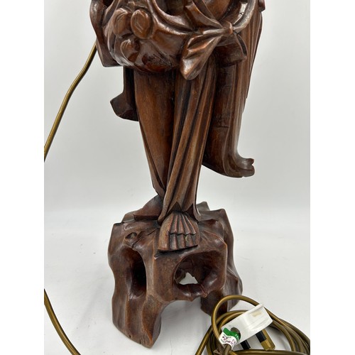 237 - A Chinese carved hardwood figure of a gentleman made into a table lamp. Height 68cm.