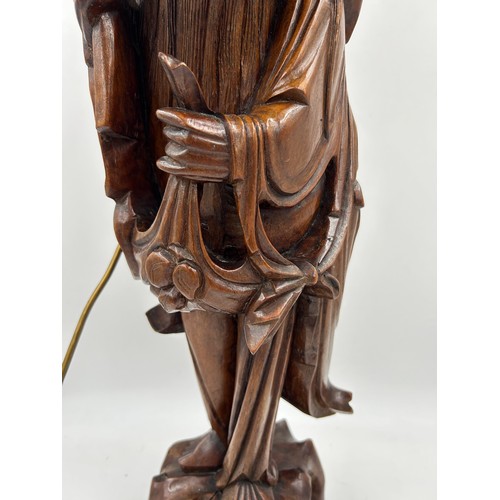 237 - A Chinese carved hardwood figure of a gentleman made into a table lamp. Height 68cm.