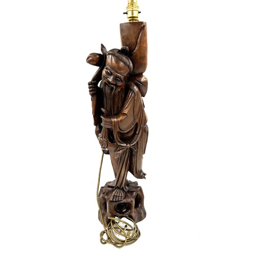 237 - A Chinese carved hardwood figure of a gentleman made into a table lamp. Height 68cm.