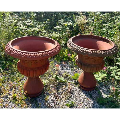 148 - A large pair of terracotta garden urns, each with egg and dart rims, Bacchanalian bodies over a part... 