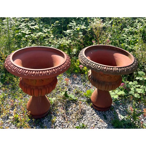 148 - A large pair of terracotta garden urns, each with egg and dart rims, Bacchanalian bodies over a part... 