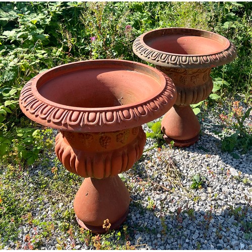 148 - A large pair of terracotta garden urns, each with egg and dart rims, Bacchanalian bodies over a part... 