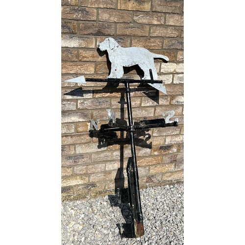 175 - A metal weather vane with dog to the top. Height approximately  76cm.