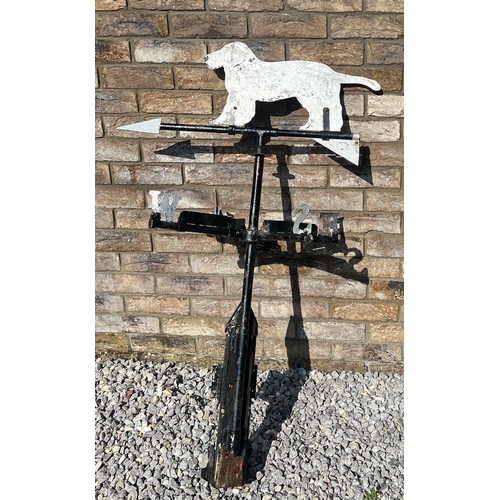 175 - A metal weather vane with dog to the top. Height approximately  76cm.