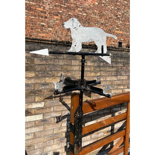 175 - A metal weather vane with dog to the top. Height approximately  76cm.