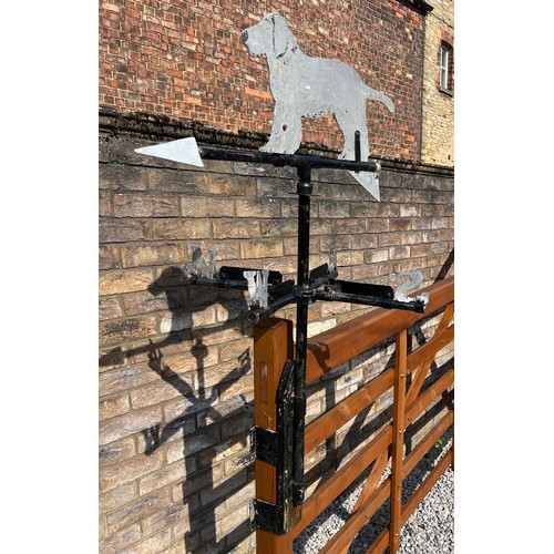 175 - A metal weather vane with dog to the top. Height approximately  76cm.