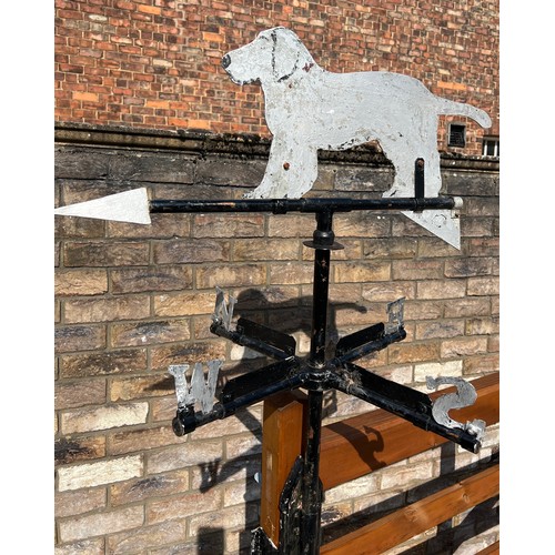 175 - A metal weather vane with dog to the top. Height approximately  76cm.