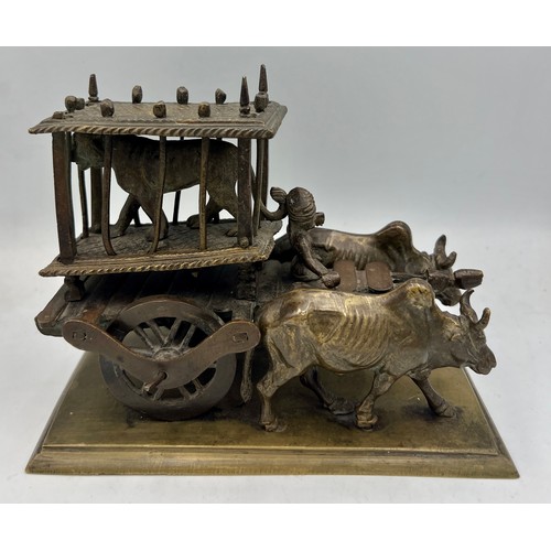 190 - An Indian brass and bronze figure of an ox cart loaded with a caged tiger. 16cm l x 12cm h.