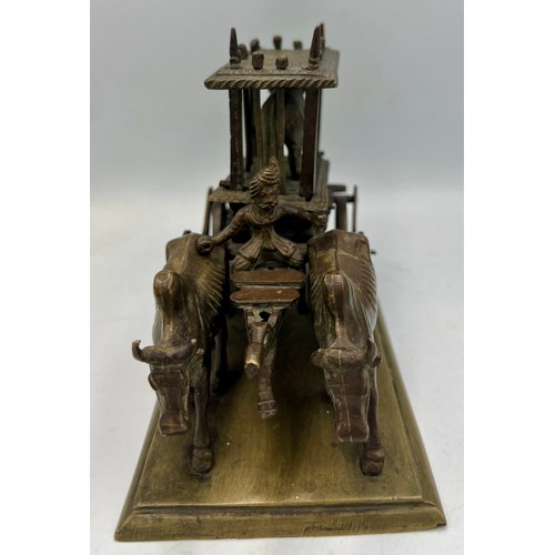 190 - An Indian brass and bronze figure of an ox cart loaded with a caged tiger. 16cm l x 12cm h.