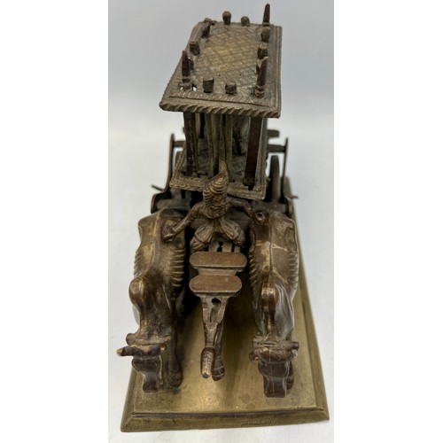 190 - An Indian brass and bronze figure of an ox cart loaded with a caged tiger. 16cm l x 12cm h.