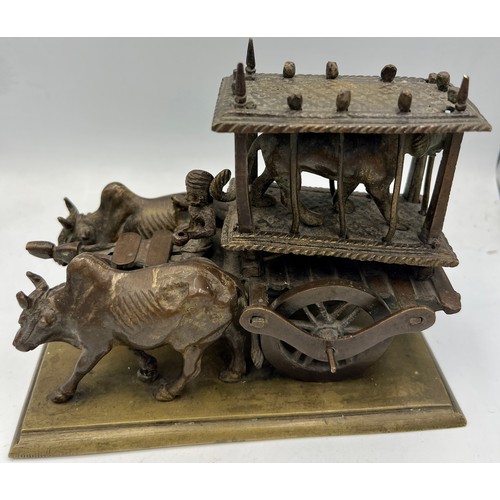 190 - An Indian brass and bronze figure of an ox cart loaded with a caged tiger. 16cm l x 12cm h.