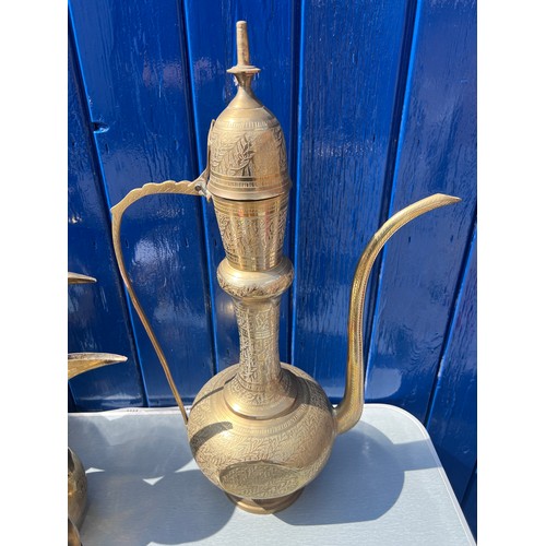 933 - Brassware to include three matching middle eastern early brass dallah coffee pots of different sizes... 