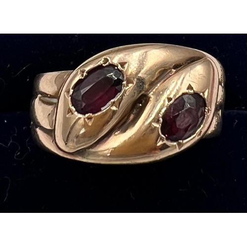 593 - A nine carat gold snake ring with garnet eyes. Weight 5.2gm. Size U.