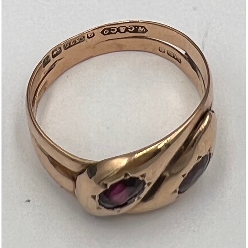 593 - A nine carat gold snake ring with garnet eyes. Weight 5.2gm. Size U.