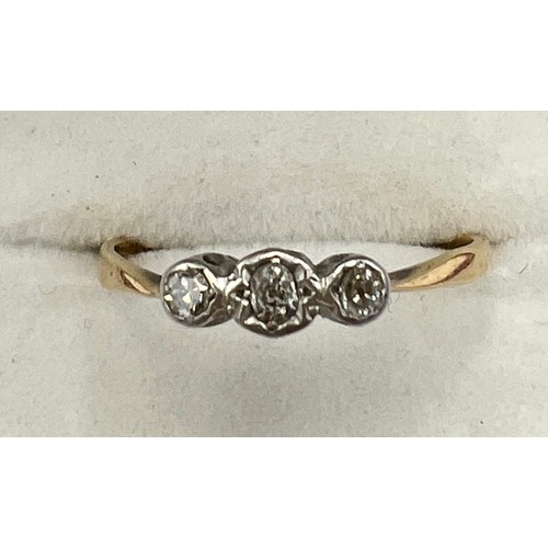 595 - A unmarked yellow and white metal ring set with three diamonds. Size R. Weight 1.9gm.