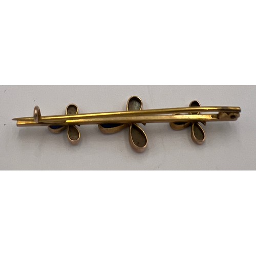 600D - A yellow metal bar brooch set with sapphire and mother of pearl. Tests as 9 carat gold. Weight 3.4gm... 