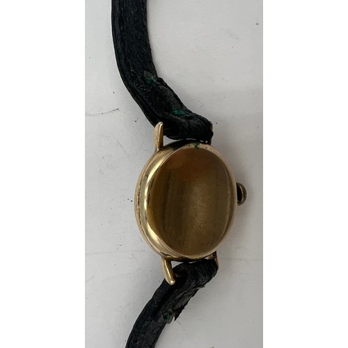 714A - A 9 carat gold cased ladies Rotary wristwatch on black leather strap. Total weight 10.4gm.