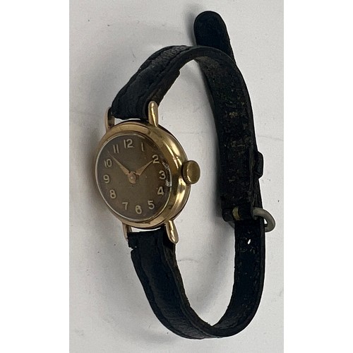 714A - A 9 carat gold cased ladies Rotary wristwatch on black leather strap. Total weight 10.4gm.