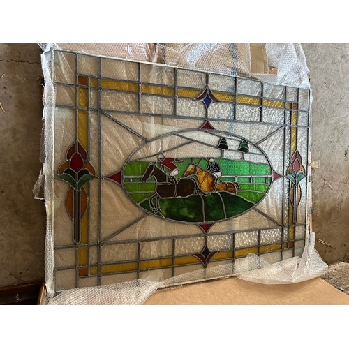 36 - A large leaded stained glass panel of racehorses. 152cm w x 114cm h.