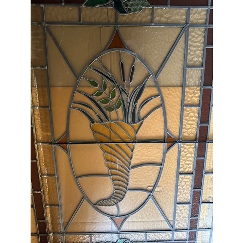 37 - A stained and leaded glass panel of a cornucopia 155cm h x 115cm w.