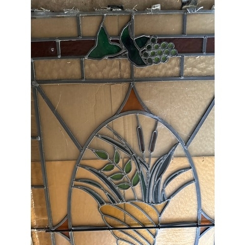 37 - A stained and leaded glass panel of a cornucopia 155cm h x 115cm w.