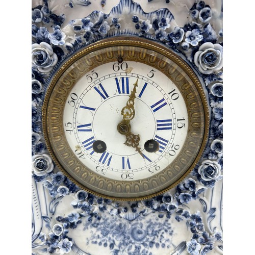 998A - A 19thC blue and white porcelain Continental clock garniture, comprising clock 38.5cm with two vases... 