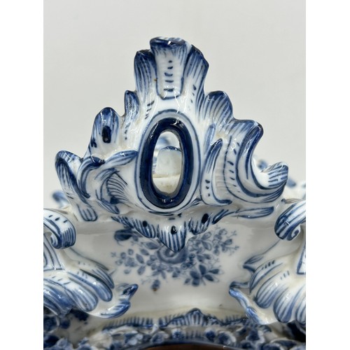 998A - A 19thC blue and white porcelain Continental clock garniture, comprising clock 38.5cm with two vases... 