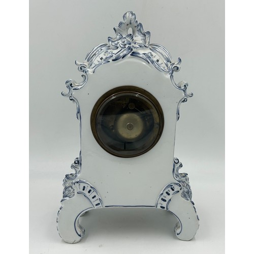 998A - A 19thC blue and white porcelain Continental clock garniture, comprising clock 38.5cm with two vases... 