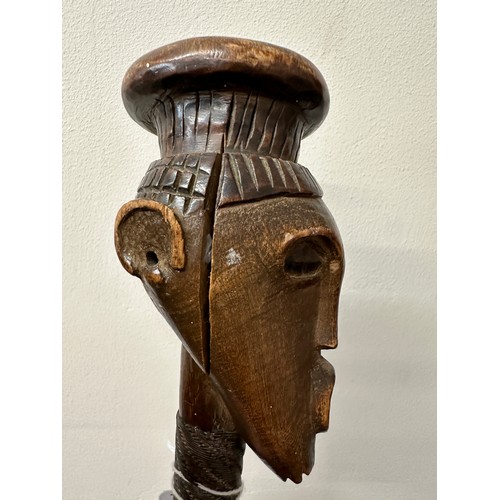 921 - An African stick with carved head and metal covered shaft, circa 1940’s, brought back to England dur... 