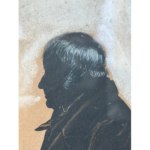 1406 - A painted silhouette of a gentleman, frame size 33cm x 26cm.