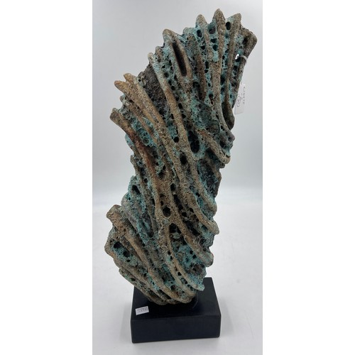 330 - Wendy Lawrence; a carved stoneware sculpture layered with textured volcanic glazes on a stone base, ... 