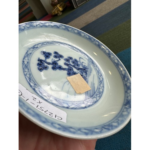 256 - A 18thC Nanking Cargo tea bowl 4cm h and saucer 11.7cm d  with underglaze blue painted decoration of... 