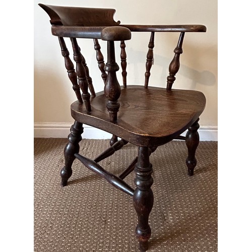 38 - An oak Captains chair. 81cm h x 50cm w x approx. 60cm d.