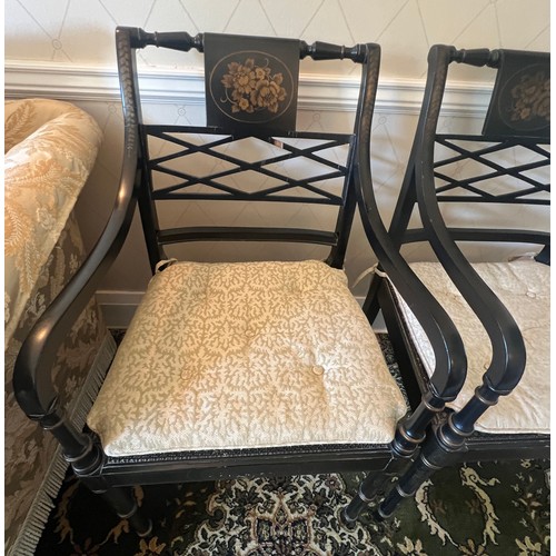 36 - A pair of ebonised armchairs with cane seats and gilt decoration.