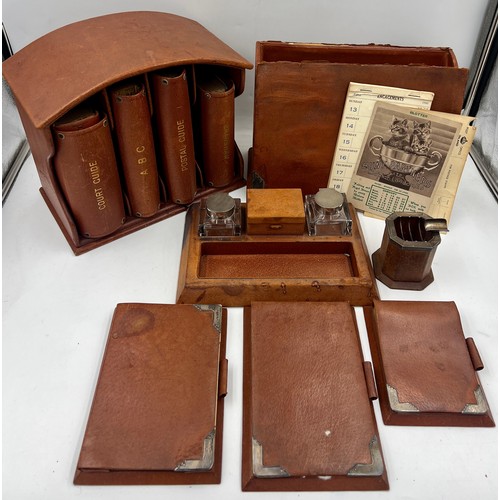 1403 - A quantity of Asprey silver and leather desk items to include stationary box, notebooks, ashtray, in... 