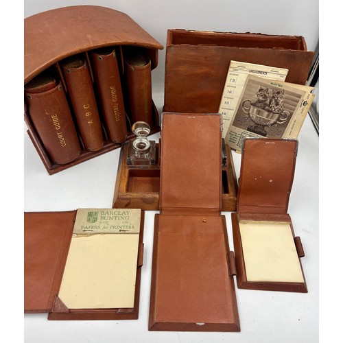 1403 - A quantity of Asprey silver and leather desk items to include stationary box, notebooks, ashtray, in... 