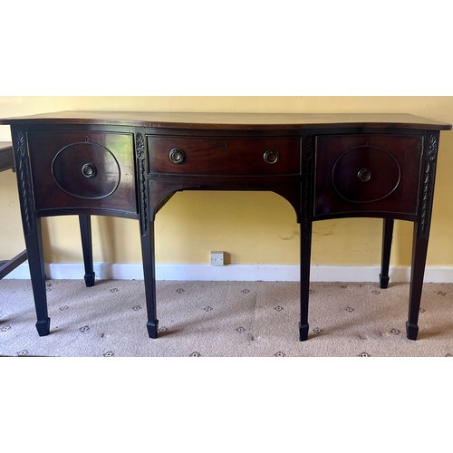 48 - A Edwardian mahogany serpentine fronted sideboard with central drawer and cupboard to either side.