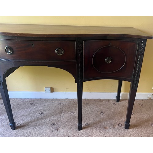 48 - A Edwardian mahogany serpentine fronted sideboard with central drawer and cupboard to either side.