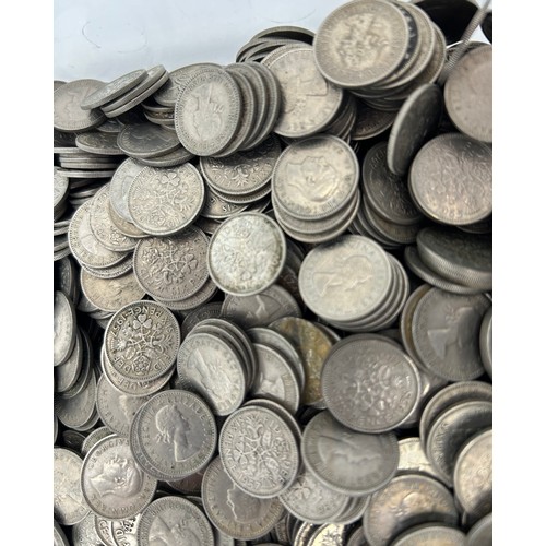 780 - A large quantity of sixpences dated 1948 -1967 along with a quantity of brass threepence pieces.