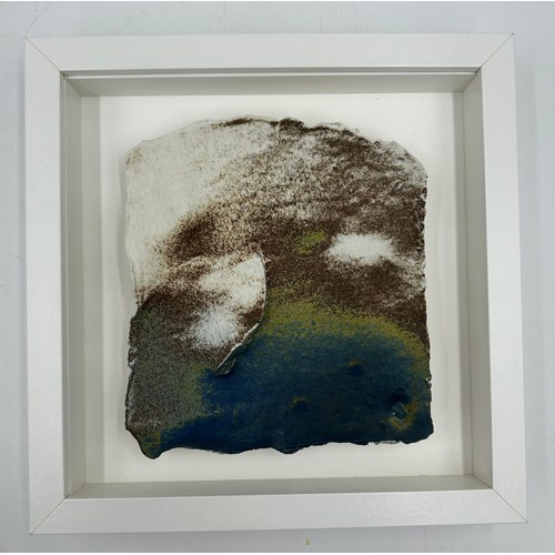 430 - A Pair of Contemporary Ceramic artworks in white box frames depicting landscapes/sea/mountains 25.5c... 