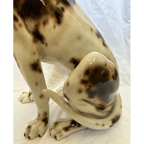 390 - A large ceramic 'Pointer' seated hunting dog in brown and white, standing 76cm h.