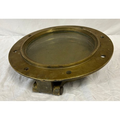 1069 - Heavy solid Brass Ships Porthole with armour plated fitted glass, 37cm d with glass 25cm.