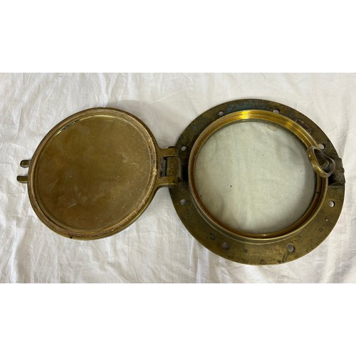 1069 - Heavy solid Brass Ships Porthole with armour plated fitted glass, 37cm d with glass 25cm.