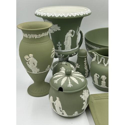 399 - A collection of green Wedgwood Jasperware to include 2 twin handled urns on with lid largest 20cm, a... 